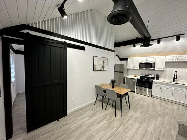 a view of a dining room with furniture and wooden floor