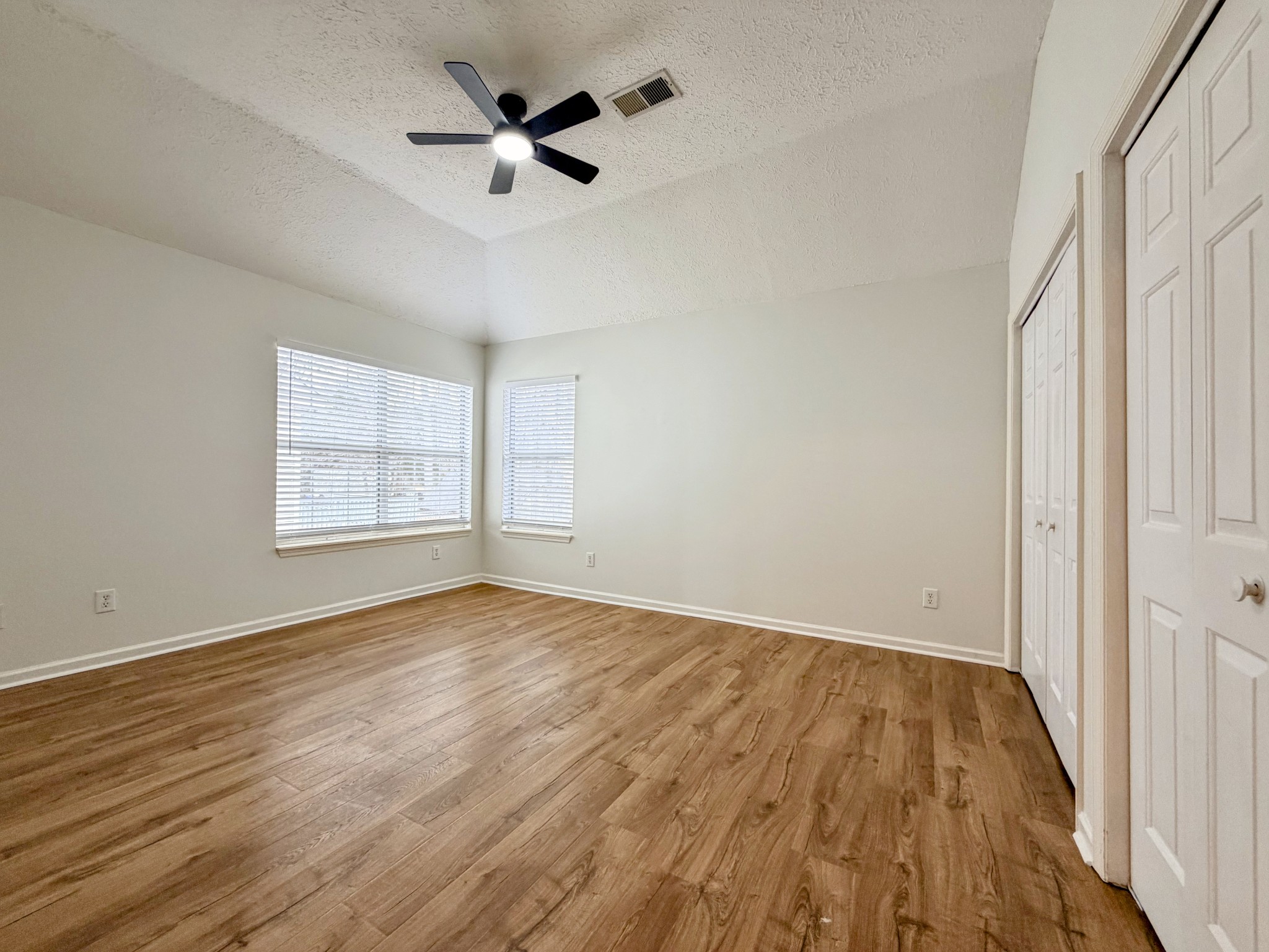 2544 Johnson Ridge Road Antioch, TN 37013 - Photo 11 of 30 an empty room with wooden floor ceiling fan and windows