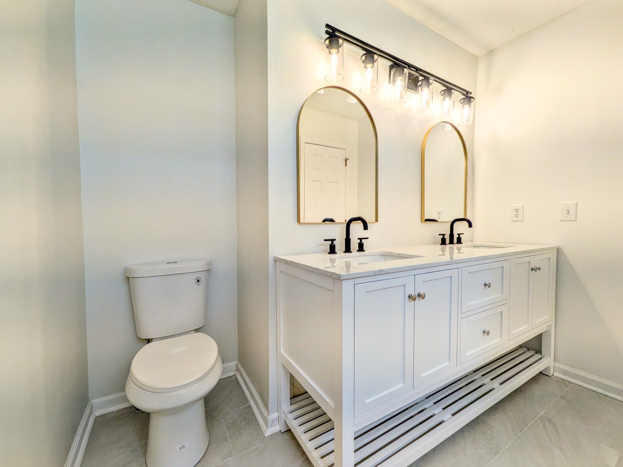 2544 Johnson Ridge Road Antioch, TN 37013 - Photo 13 of 30 a bathroom with a double vanity sink toilet and a tub