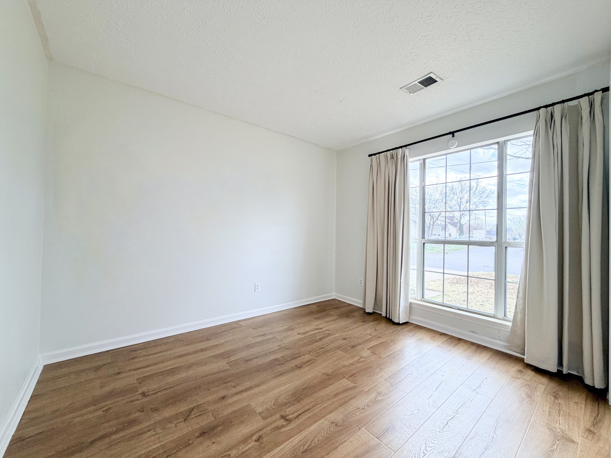 2544 Johnson Ridge Road Antioch, TN 37013 - Photo 15 of 30 a view of an empty room with wooden floor and a window
