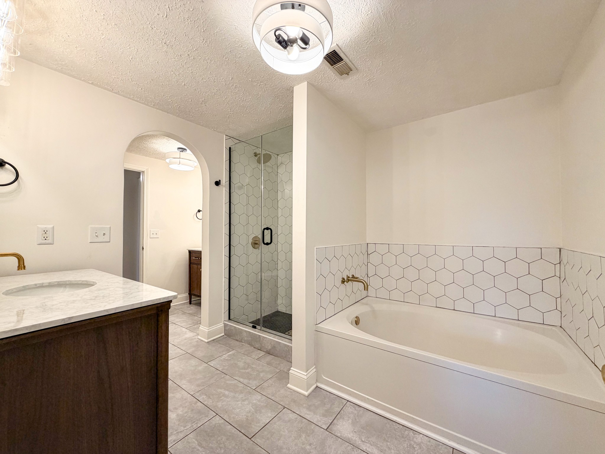 2544 Johnson Ridge Road Antioch, TN 37013 - Photo 21 of 30 a bathroom with a bathtub a sink and a shower