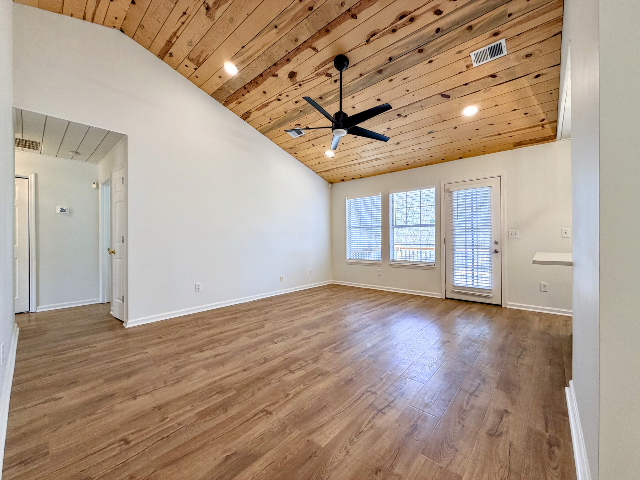 2544 Johnson Ridge Road Antioch, TN 37013 - Photo 3 of 30 a view of an empty room with wooden floor and a window