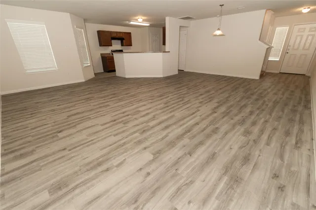 a view of a kitchen with a sink and a refrigerator