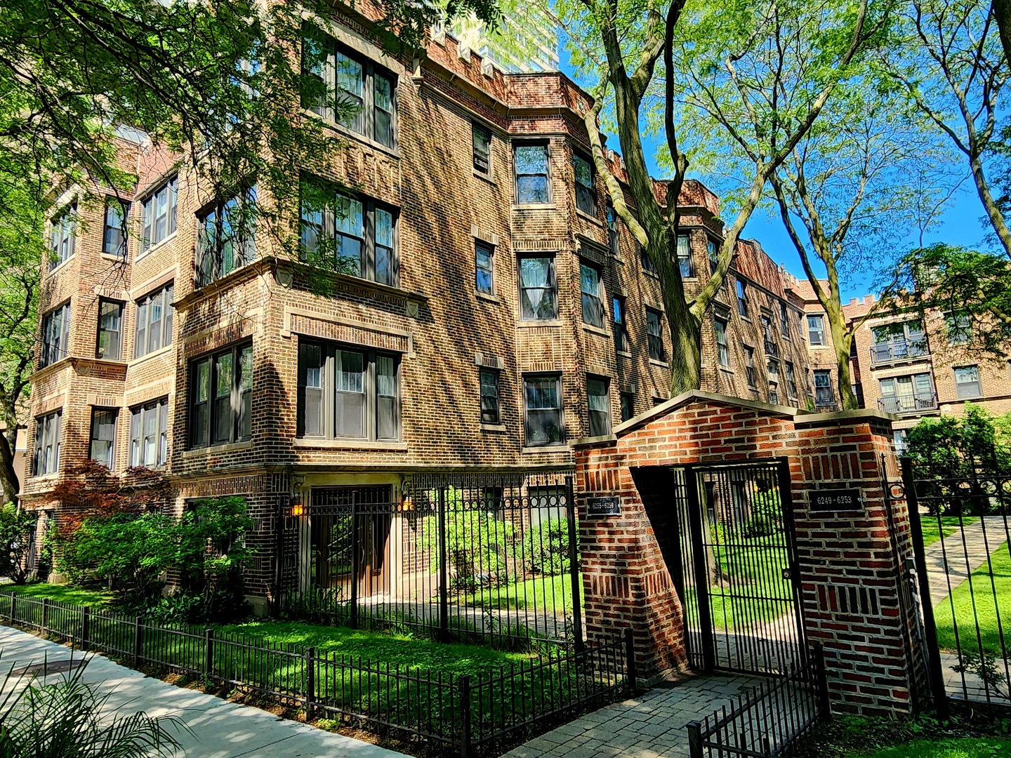 a front view of a residential apartment building with a yard