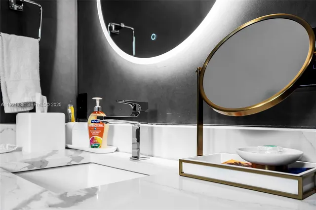 a bathroom with a granite countertop shower a mirror and toilet