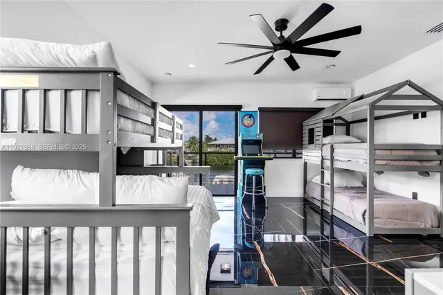 a bedroom with a bed a couch and a flat screen tv