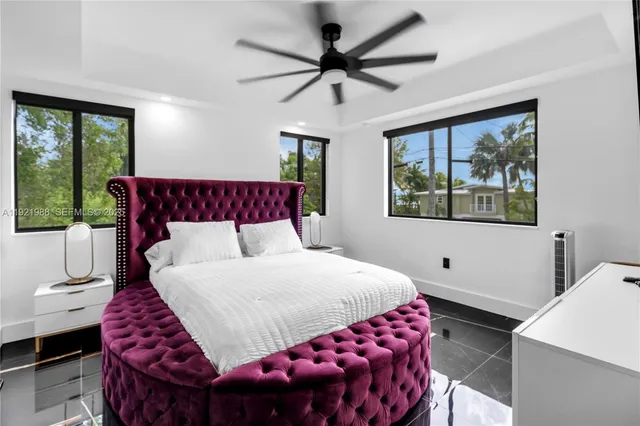 a bedroom with a bed and a window