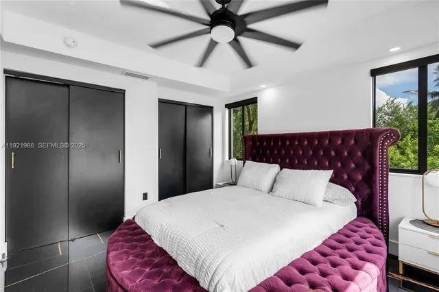 a bedroom with a bed and a ceiling fan