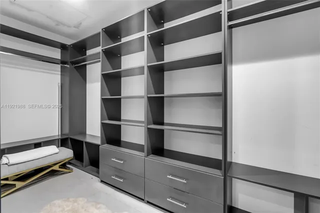 a view of a room with gym equipment and large window