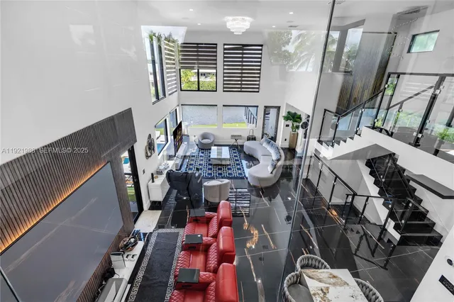a living room with fireplace furniture and a floor to ceiling window