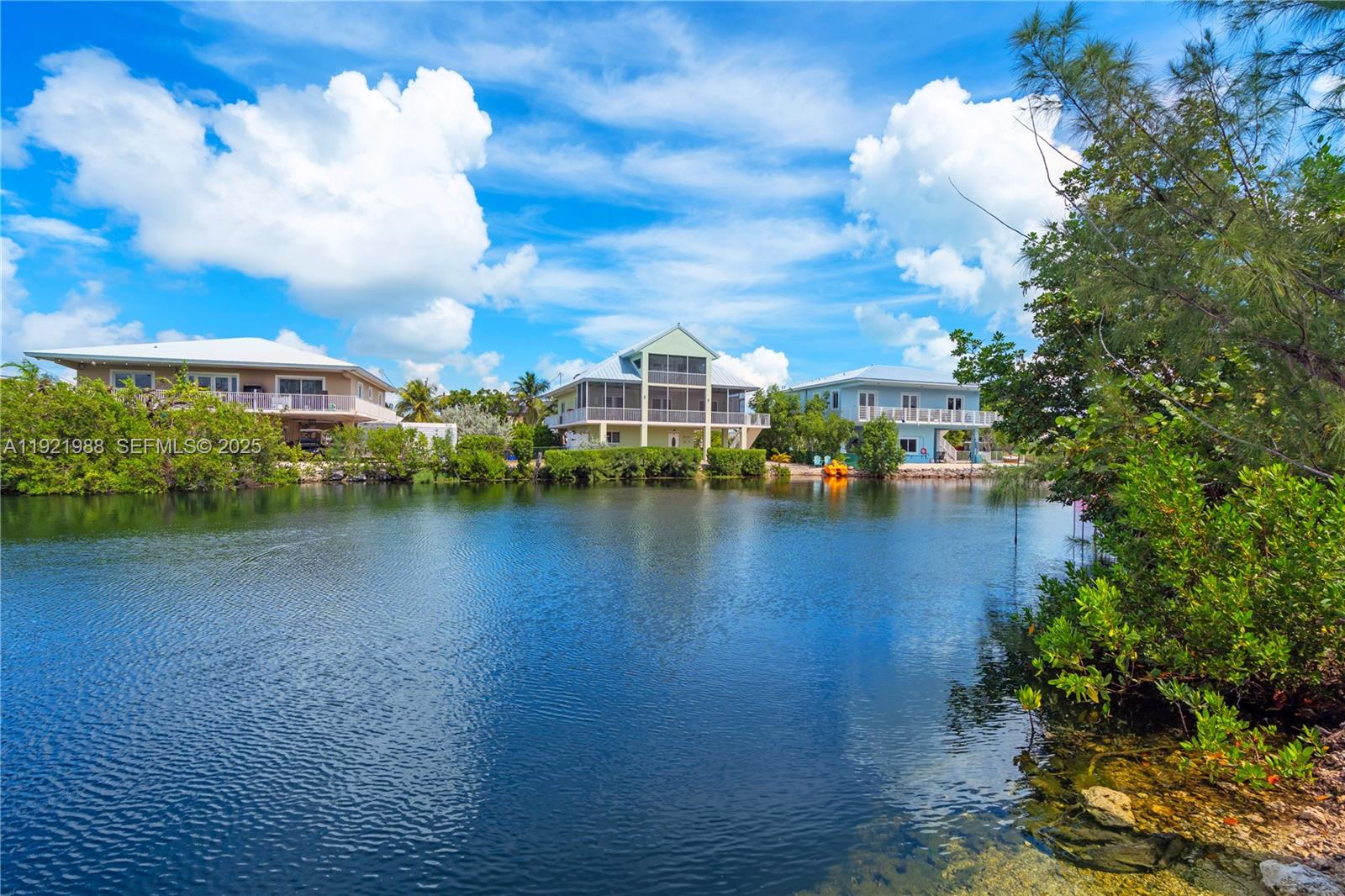 32 North Bounty Lane Key Largo, FL 33037 - Photo 66 of 86 a view of a lake with a house in the background
