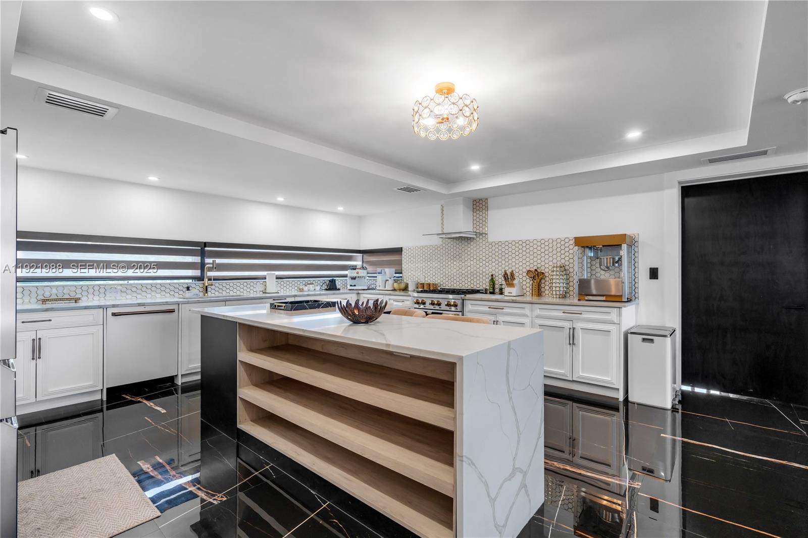 32 North Bounty Lane Key Largo, FL 33037 - Photo 10 of 86 a kitchen with kitchen island granite countertop a sink cabinets and stainless steel appliances