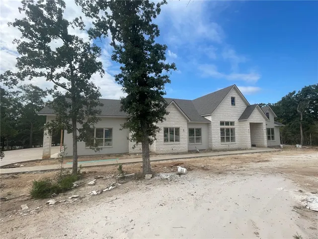 a kitchen with stainless steel appliances granite countertop a stove top oven and cabinets