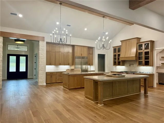 a kitchen with cabinets and stainless steel appliances