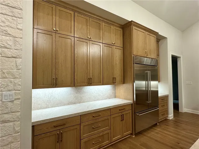 an empty room with wooden floor and fireplace