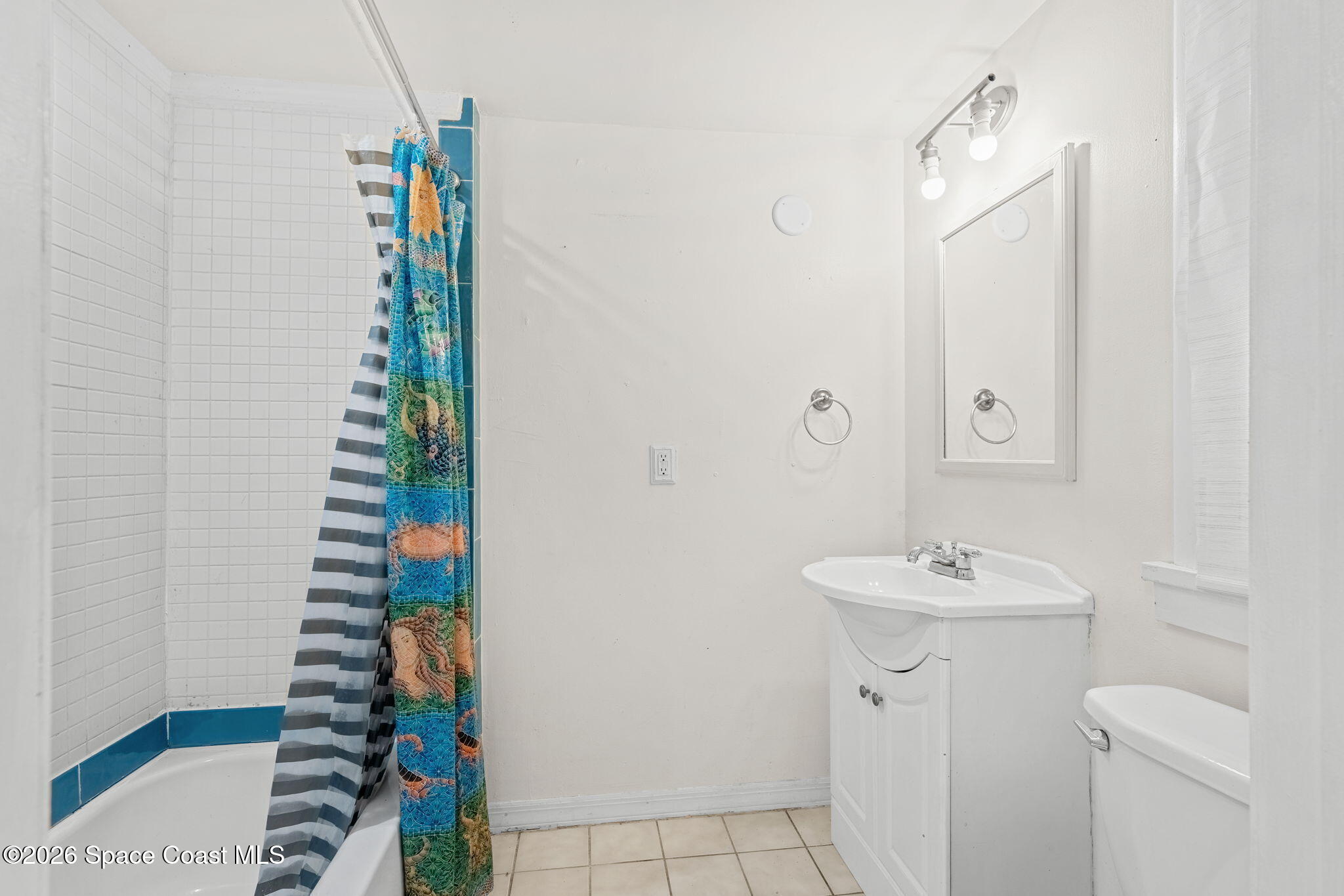 1101 Rockledge Drive Rockledge, FL 32955 - Photo 61 of 76 a bathroom with a sink and a mirror