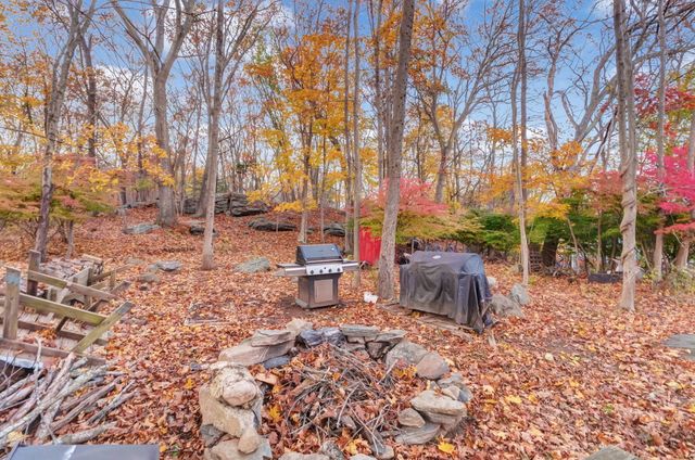 a backyard of a house with table and chairs