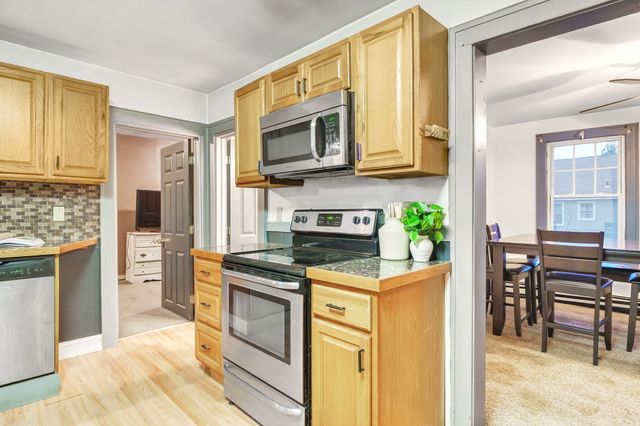 a kitchen with stainless steel appliances granite countertop a stove and a refrigerator