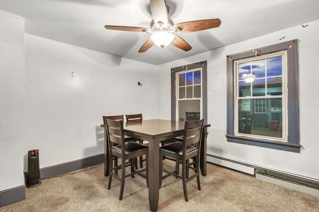 a view of a dining room with furniture and a chandelier