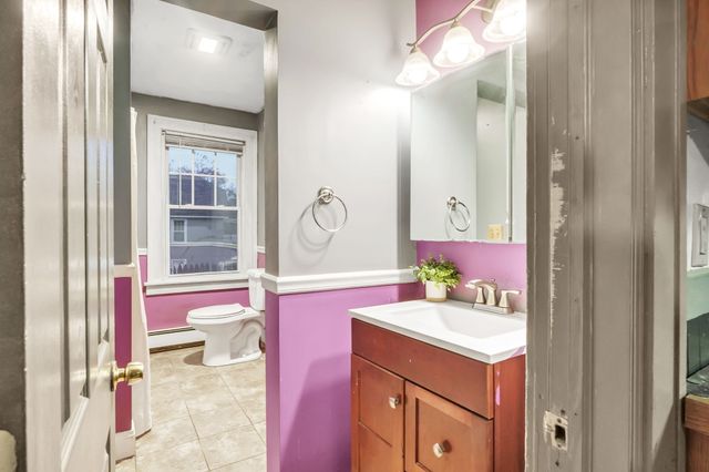 a bathroom with a sink vanity tub and a mirror