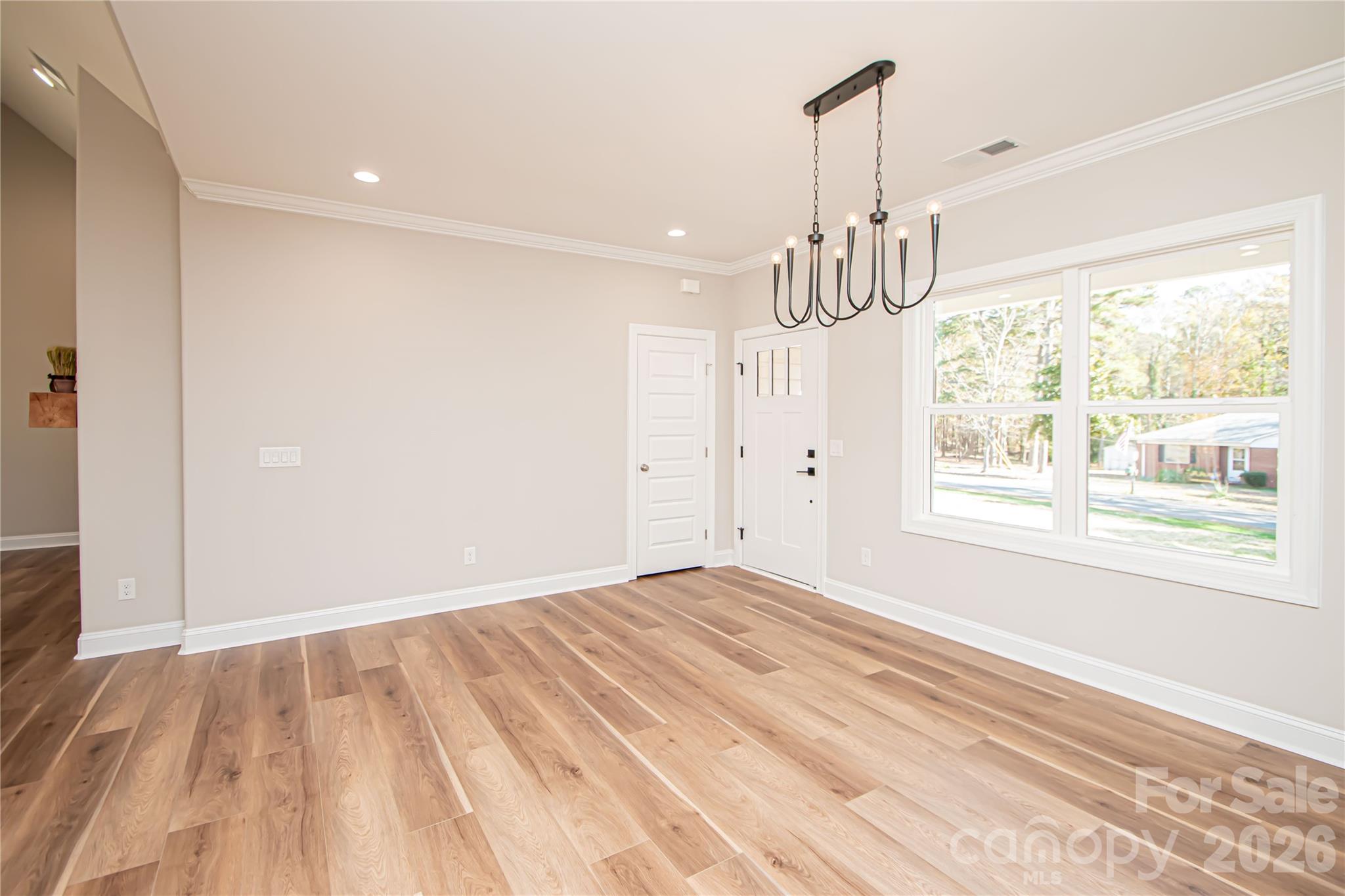 1508 Marion Street Monroe, NC 28112 - Photo 17 of 48 a view of empty room with wooden floor and fan