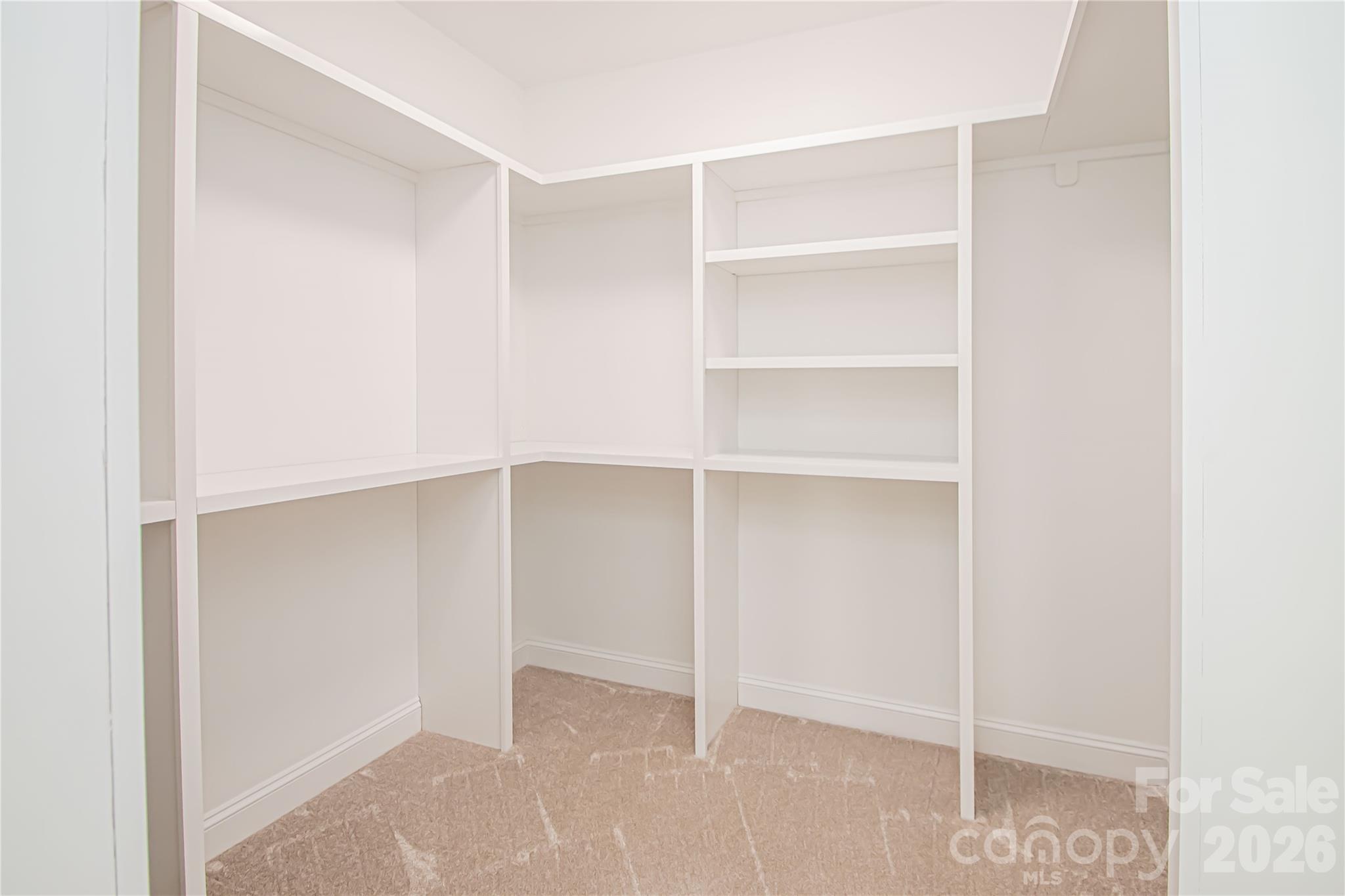1508 Marion Street Monroe, NC 28112 - Photo 22 of 48 a view of an empty walk in closet with empty racks