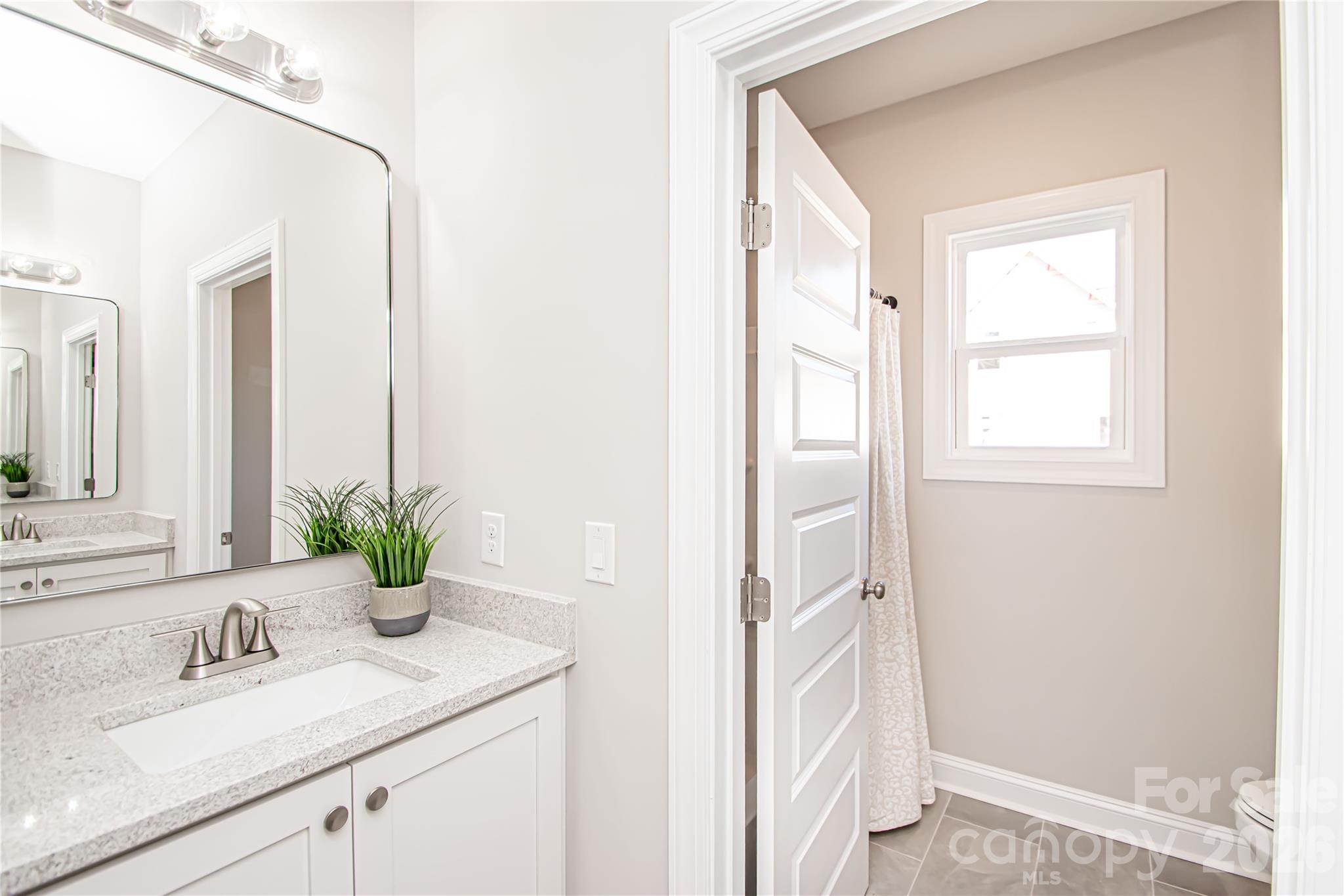 1508 Marion Street Monroe, NC 28112 - Photo 34 of 48 a bathroom with a granite countertop sink and a mirror