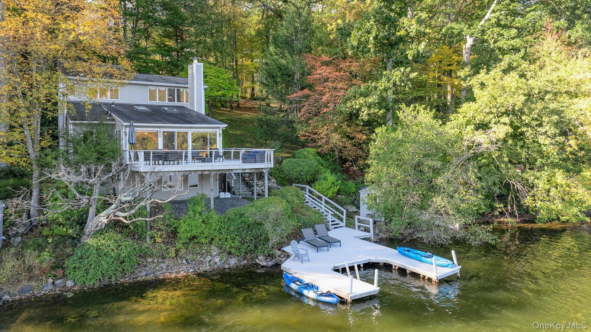 an aerial view of a house with swimming pool outdoor seating and yard