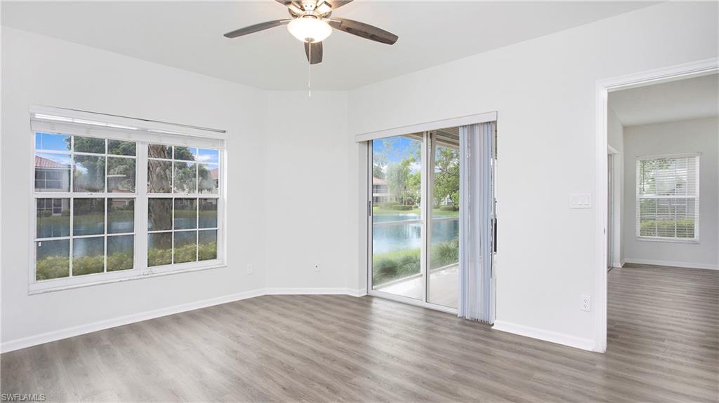 6225 Bellerive Avenue, Unit 1501 Naples, FL 34119 - Photo 17 of 22 a view of an empty room with wooden floor and a window