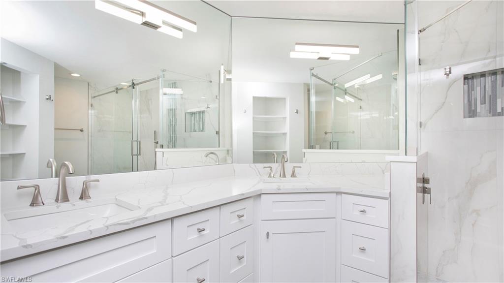 6225 Bellerive Avenue, Unit 1501 Naples, FL 34119 - Photo 19 of 22 a bathroom with a sink and a mirror