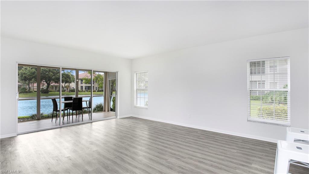 6225 Bellerive Avenue, Unit 1501 Naples, FL 34119 - Photo 2 of 22 wooden floor in an empty room with a window