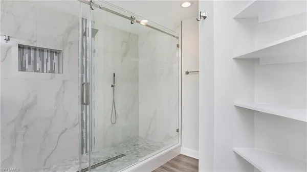 a bathroom with a glass shower door