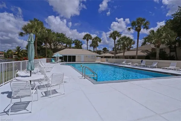 a view of a house with swimming pool and sitting area