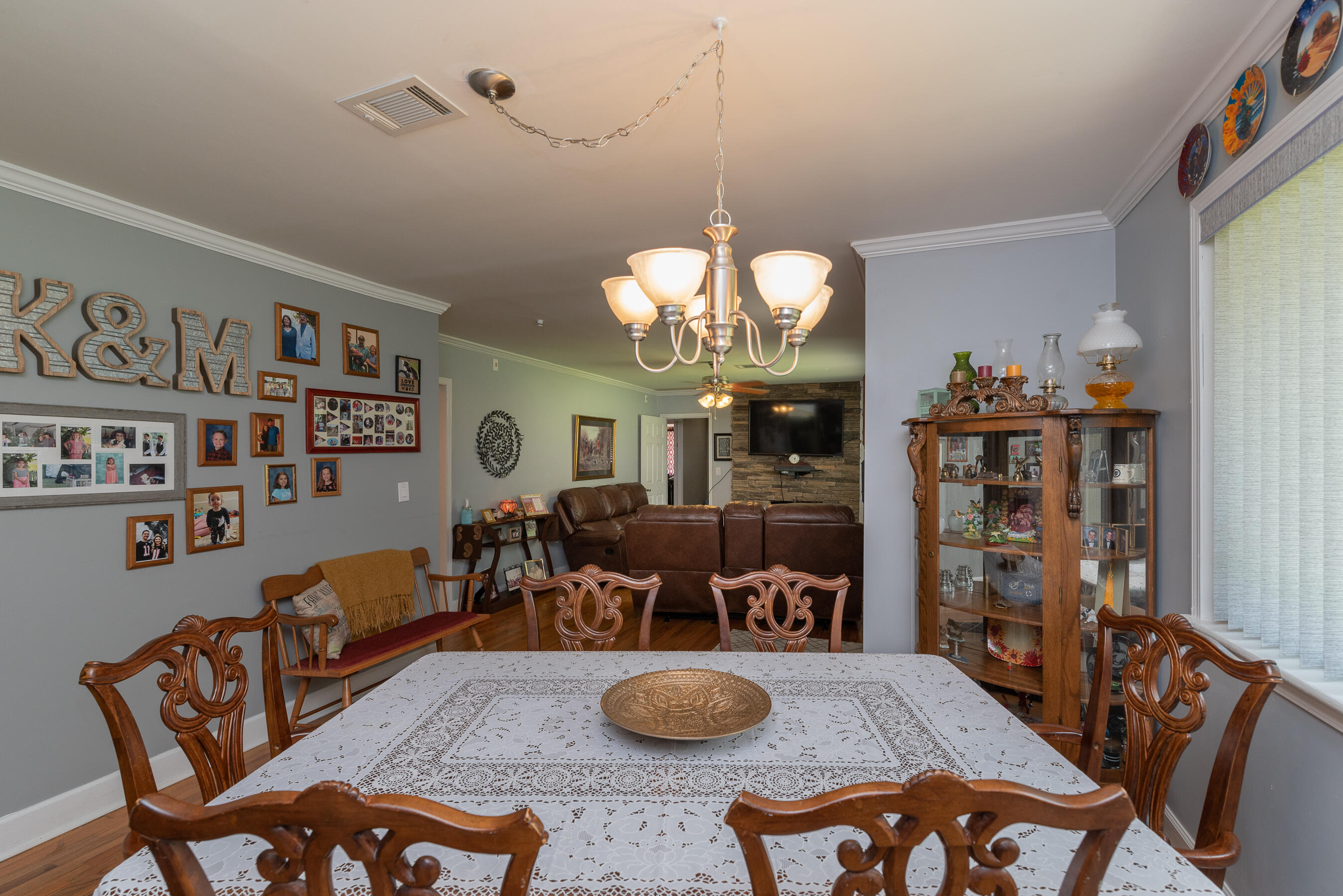 2005 Robin Road North Augusta, SC 29841 - Photo 10 of 36 a living room with furniture a chandelier and a bookshelf