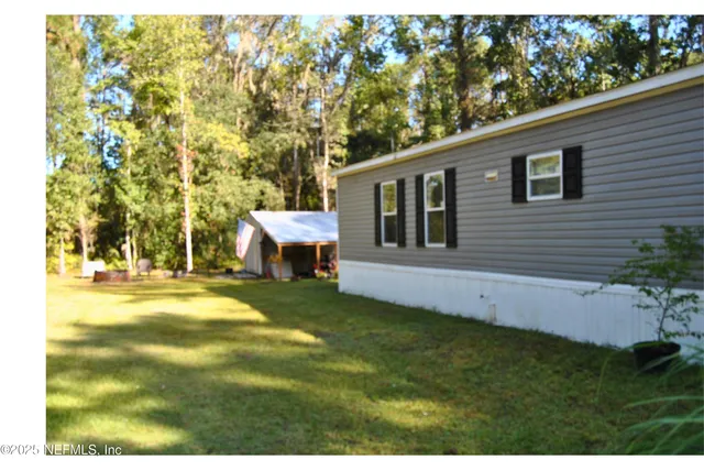 a backyard of a house with table and chairs
