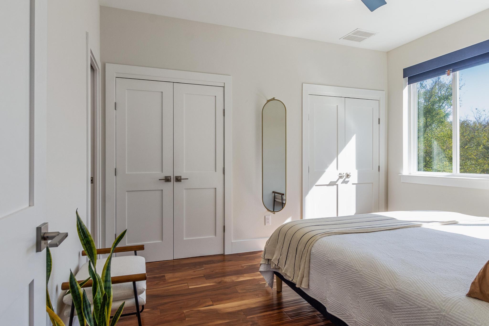 1177 Pandora Street, Unit B Austin, TX 78702 - Photo 14 of 30 Bedroom featuring multiple closets and dark wood finished floors