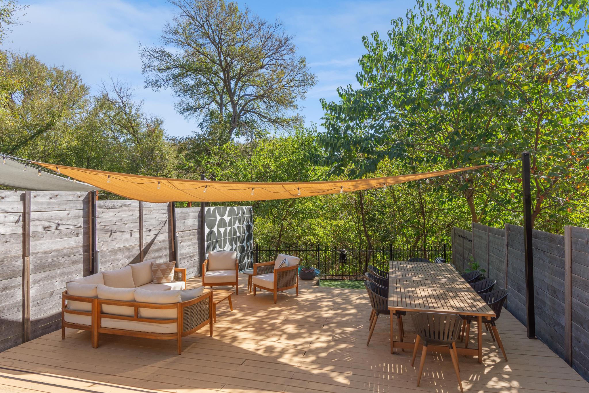 1177 Pandora Street, Unit B Austin, TX 78702 - Photo 26 of 30 Wooden terrace featuring an outdoor living / dining area and a fenced backyard