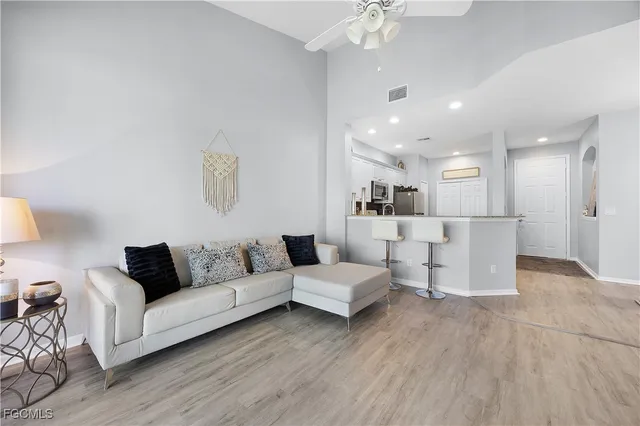 a living room with furniture and kitchen view