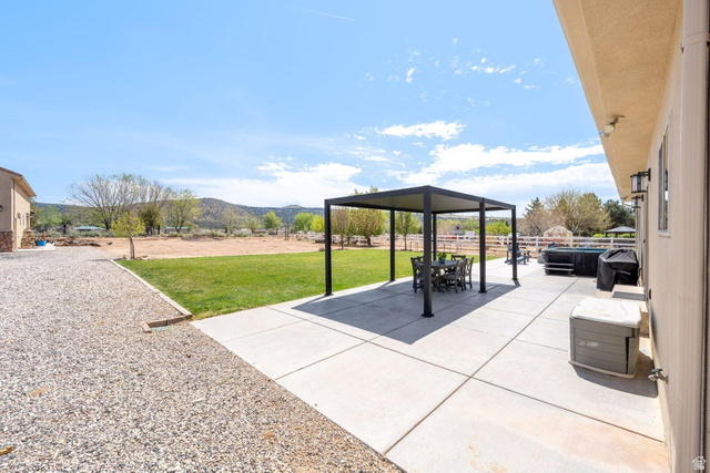 7776 Wagon Road East St. George, UT 84770 - Photo 48 of 76 View of patio / terrace featuring a mountain view, a gazebo, and outdoor dining space