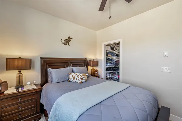 a bedroom with a bed and a night stand