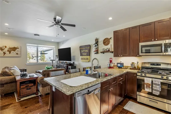 a kitchen with a stove a sink and a microwave