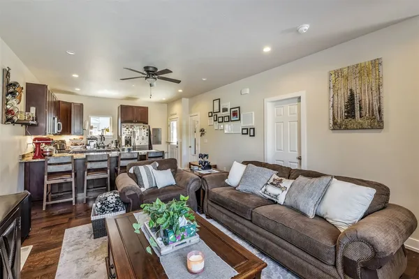 a living room with furniture and kitchen view
