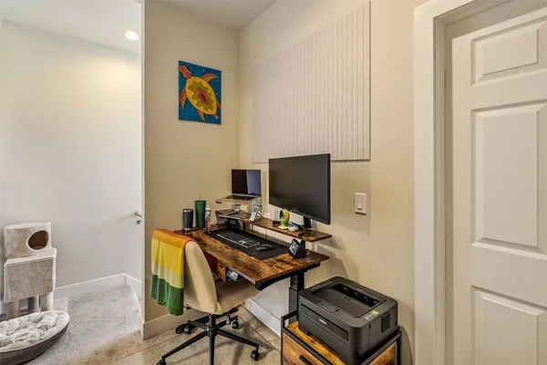 a view of a workspace with furniture and wooden floor