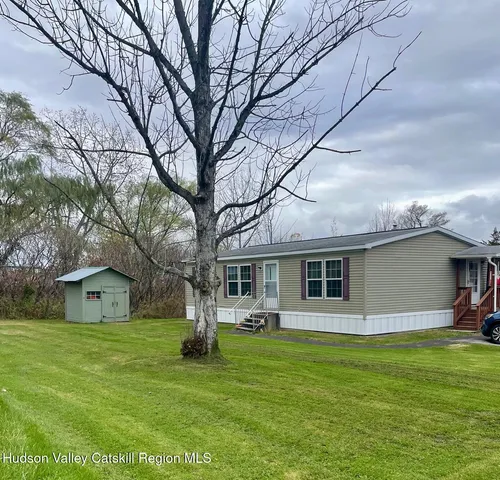 a front view of house with yard and green space