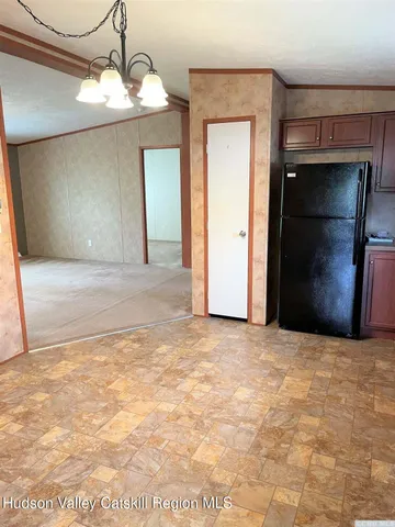 a view of an empty room with a chandelier