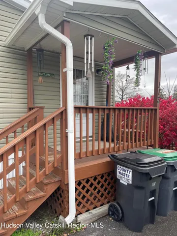 a outdoor sitting area with wooden walls and a window