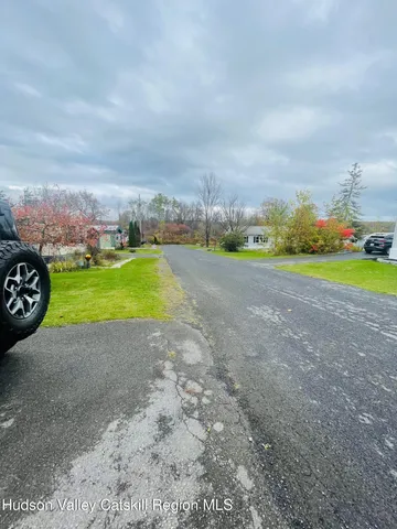 a view of a field with trees in the background