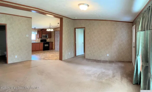 a view of a hallway with a livingroom