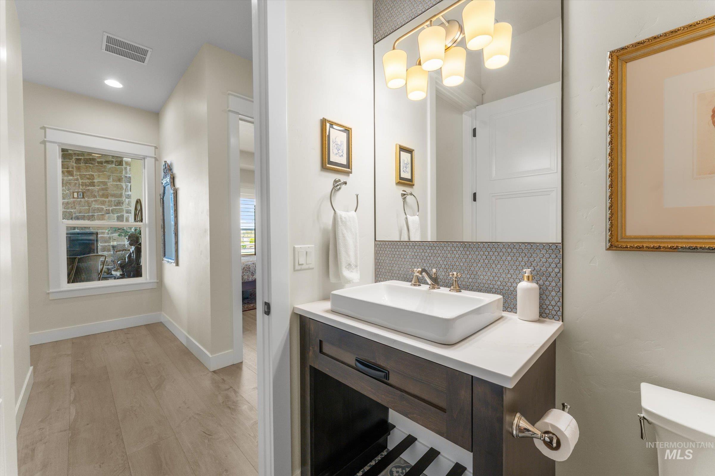 6585 South Pemberley Way Meridian, ID 83642 - Photo 22 of 43 Modern vanity with a rectangular vessel sink, gold-finish faucet, and white countertop
