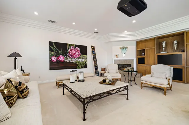 a kitchen with stainless steel appliances granite countertop a stove top oven a sink dishwasher a dining table and chairs with wooden cabinets